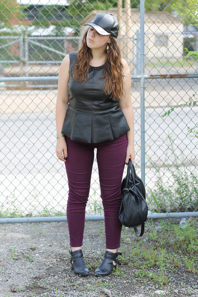 Leather Pops Outfit: Plum AG Stevie Ankle Jeans from Anthropologie, faux leather peplum top from Urban Outfitters, black leather Jeffrey Campbell Everly cutout ankle boots, leather baseball cap, studded-bottom bag