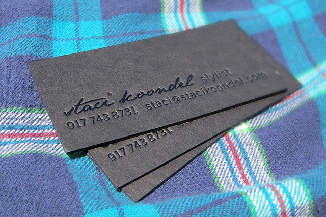 Letterpress and black foil stamp business card on black museum board