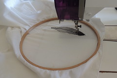 Stitching the feather to the shirt