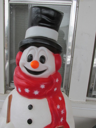 A seasonal outdoor light up plastic snowman on the front porch.  Elmwood Park Illinois.  December 2013. by Eddie from Chicago