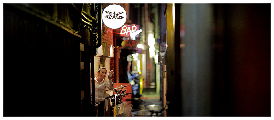 Japanese Woman Waving Goodbye, Bar tonbo near Pontocho in Kyoto – Japan