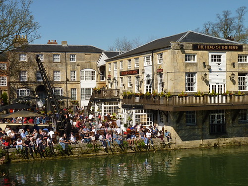 Crowded courtyard outside the Head of the River pub with the River Thames in the foreground