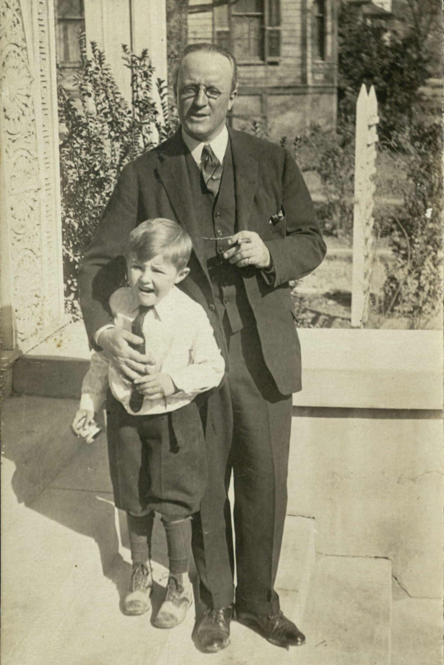 Carl Lovelace with one of his sons outside their home in Waco, undated