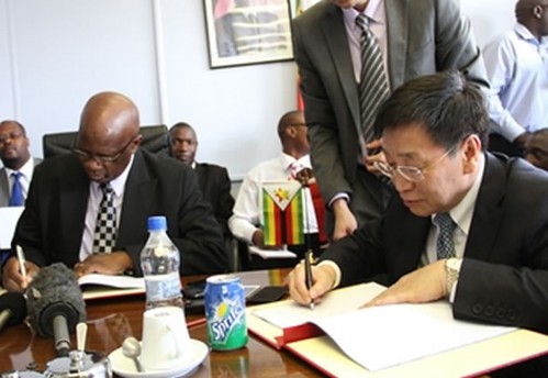 Republic of Zimbabwe Minister of Finance Patrick Chinamasa along with  Vice-President of the People's Republic of China Import-Export Bank Zhu Hongjie signing a $318 million hydro power contract in Harare. by Pan-African News Wire File Photos