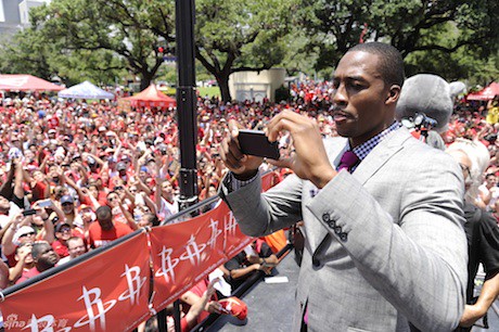 July 13, 2013 - Dwight Howard takes a photo of the crowd that came to greet him at his welcome rally