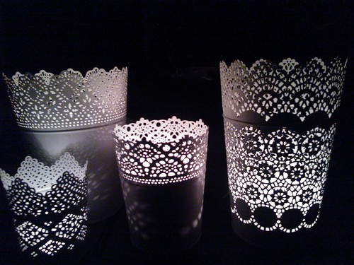 White lace-like metal luminaries, night light playing from votive candles, Seattle, Washington, USA by Wonderlane