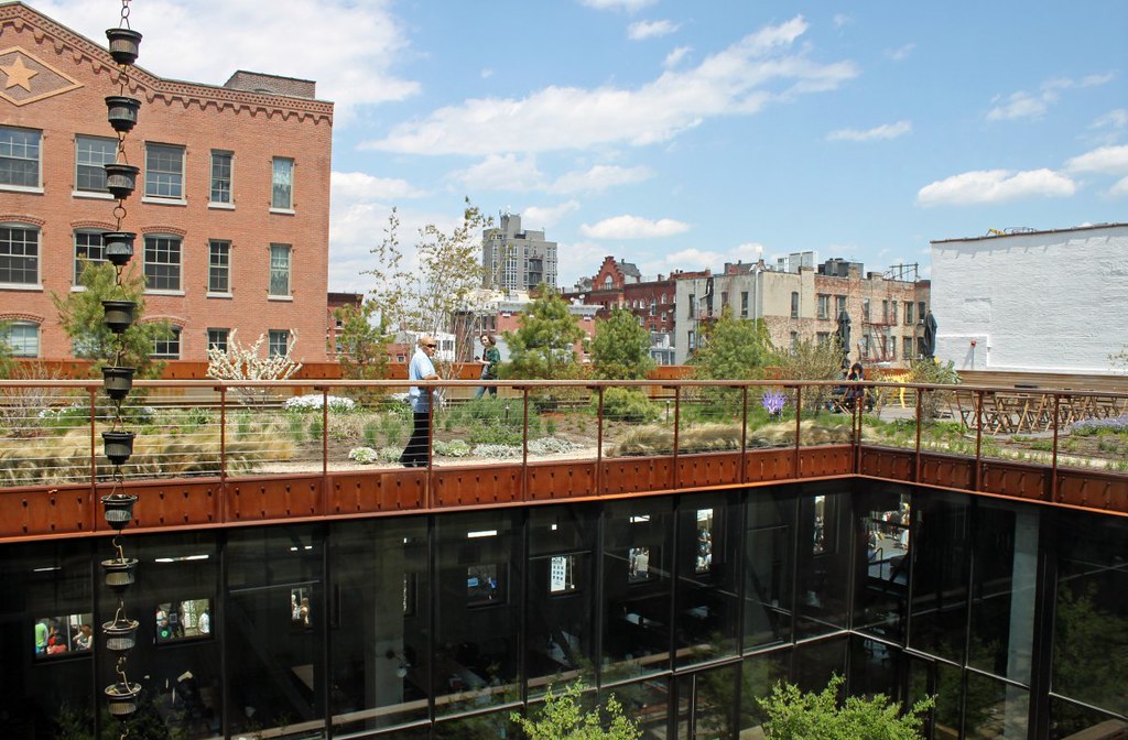 across-the-inner-courtyard-you-can-see-people-hanging-out-in-the-rooftop-garden