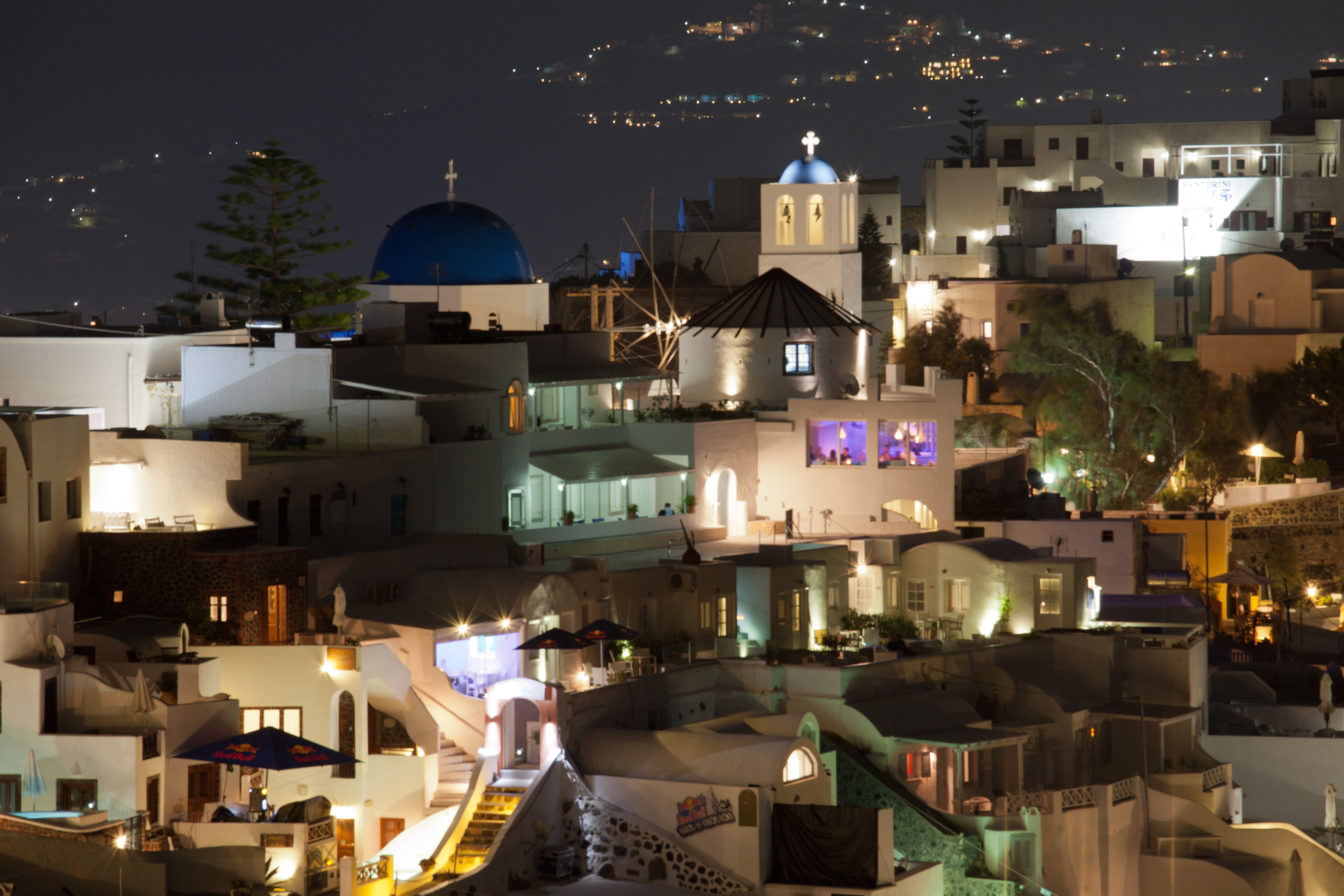 Town of Firostefani, Santorini, Greece at night with blue domed church