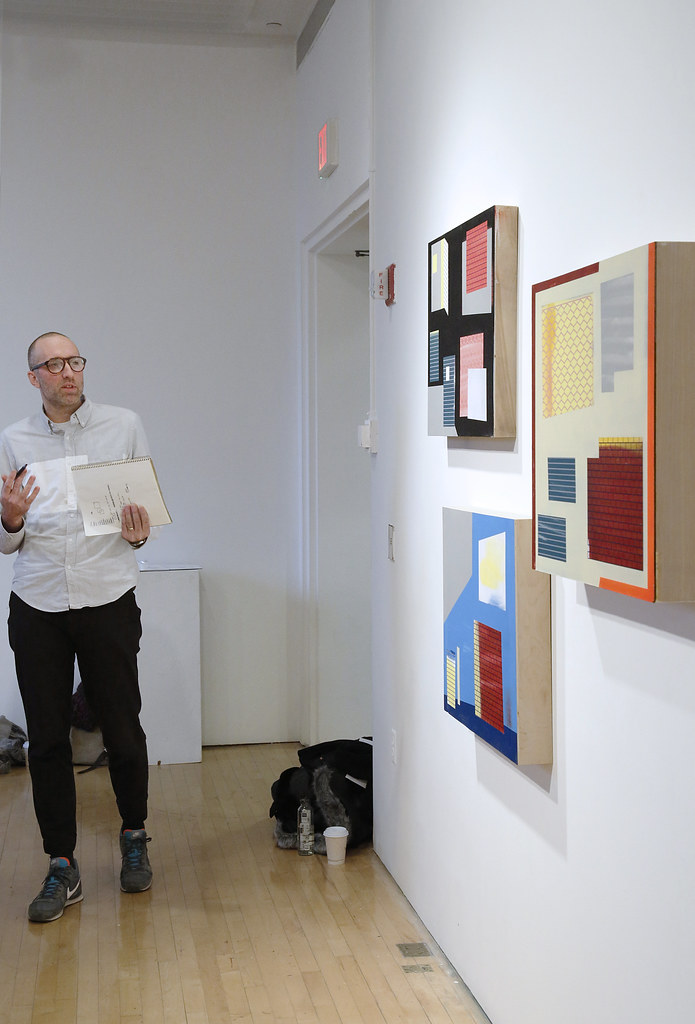 Kaleb Hunkele (M.F.A. '18) presents his paintings during the M.F.A. all-faculty critique.