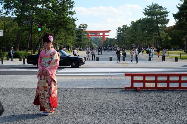 Japanese lady poses in front of Torii Gate