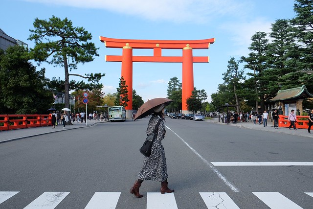 Lady in front of a giant Torii Gate