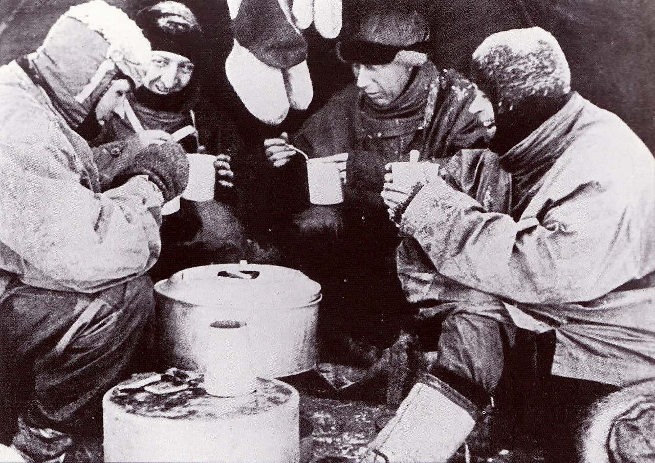 Mealtime during the Terra Nova Expedition. From left to right - Evans, Bowers, Wilson and Scott