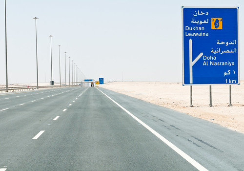 road travel blue sky brown texture abandoned sign yellow digital truck geotagged concrete grey dangerous nikon asia outdoor stones gray line freeway minimalism distance qatar lightroom d300 fatamorgana gettyvacation2010 christiansenger:year=2011