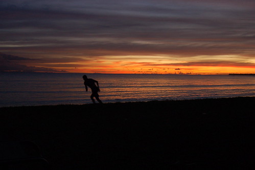 sunset shadow sea orange man water running tobago runningman canoebay