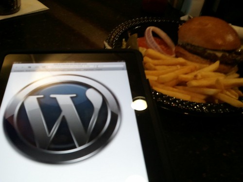 WordPress logo next to a burger waiting for a flight home to seattle