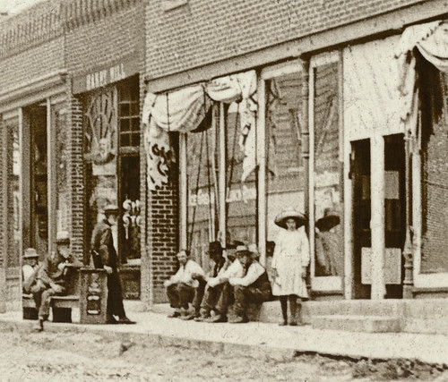girls people usa signs men history sepia kids buildings advertising children awning cafe furniture restaurants indiana streetscene pedestrians storefronts businesses barbers departmentstores ossian realphoto wellscounty hoosierrecollections