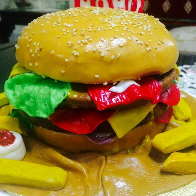 Vanilla funfetti and chocolate chip cake carved in the shape of a scrumptious Beef burger served with cookie fries by Alliya Nasir