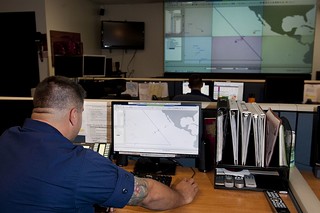 U.S. Coast Guard Operations Specialist 1st Class Andrew Lincoln, 14th Coast Guard District Command Center operations unit controller, monitors vessel traffic using the Automated Mutual-Assistance Vessel Rescue (AMVER) system within the Joint Rescue Coordination Center's area of responsibility throughout the Pacific region at the JRCC May 8, 2014, in Honolulu. Lincoln helps monitor an AOR that spans more than 12 million nautical miles. (U.S. Air Force photo by Staff Sgt. Christopher Hubenthal)