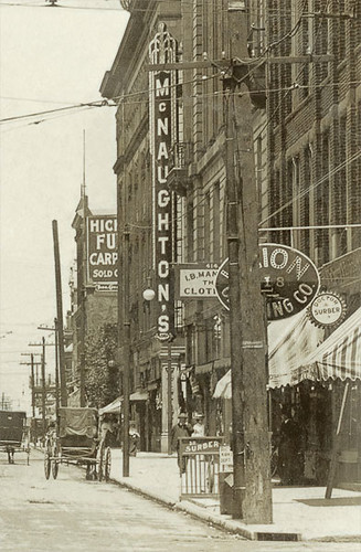 horses people usa signs man men history sepia buildings walking advertising awning hardware clothing indiana streetscene bicycles departmentstore transportation shops pedestrians storefronts theaters doctors buggy muncie buggies businesses wagons theatres lampposts streetcars delawarecounty realphoto hoosierrecollections