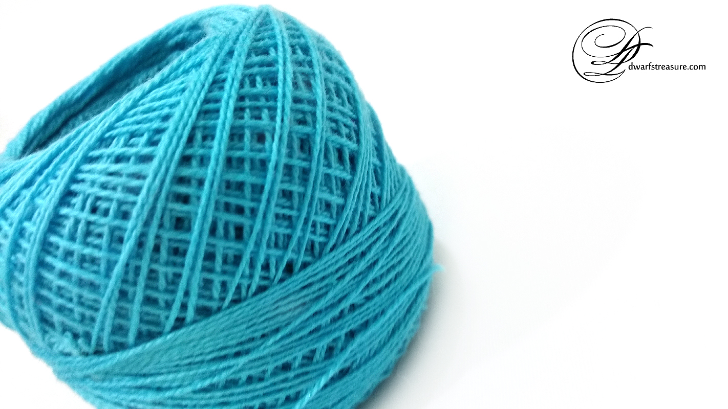 teal soft single cotton yarn ball on white background