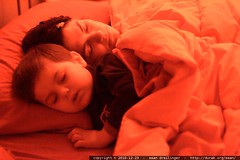 sleeping beauties   mother and son asleep in bed 