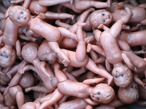 A pile of plastic pink naked baby dolls