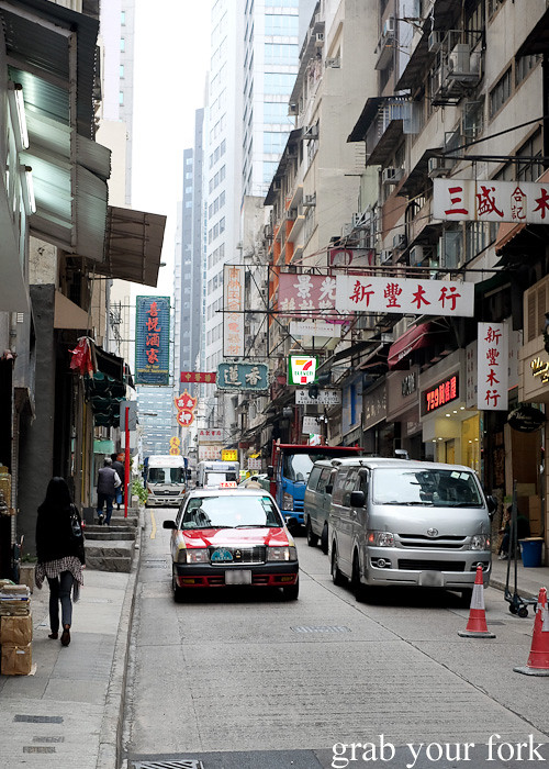 Queens Road shops and traffic in the Central district, Hong Kong