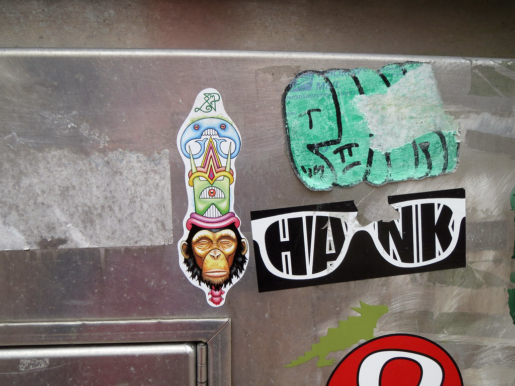 Monkey head wth crazy stuff on top sticker in UIUC campustown