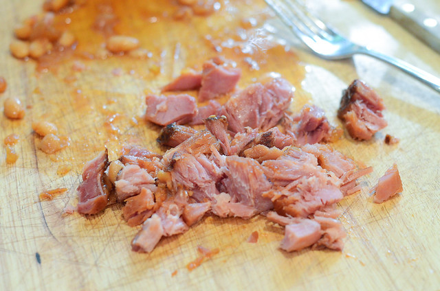 Ham is removed from the ham bone and chopped on a cutting board.