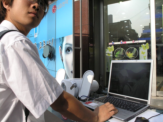 Man try laptop at outside display at Store