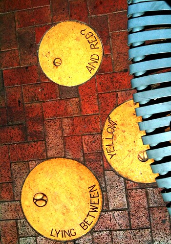 red yellow metal bench chinatown adelaide lying brass between slat embedded theen iphone3gs