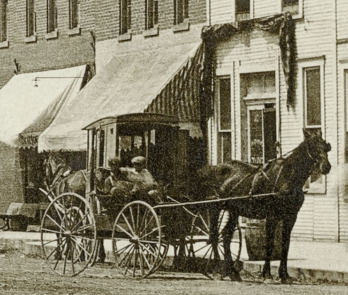 horses people woman usa signs man men history buildings walking advertising awning clothing women indiana streetscene transportation drugs shops pedestrians storefronts doctors buggy mooresville buggies businesses wagons realphoto hoosierrecollections