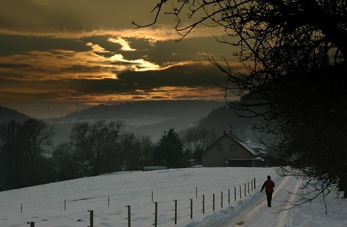 winter sunset sun snow man clouds walking person track