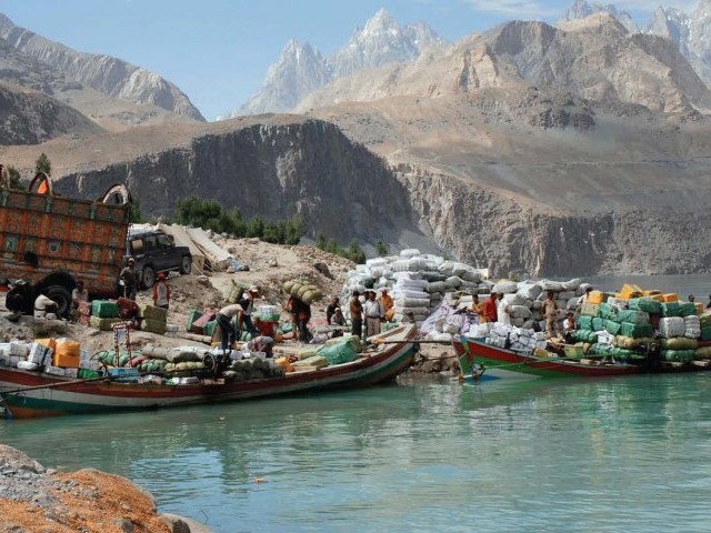 Local traders using boats to carry goods at Attabad Lake. PHOTO courtesy by: Express Tribune