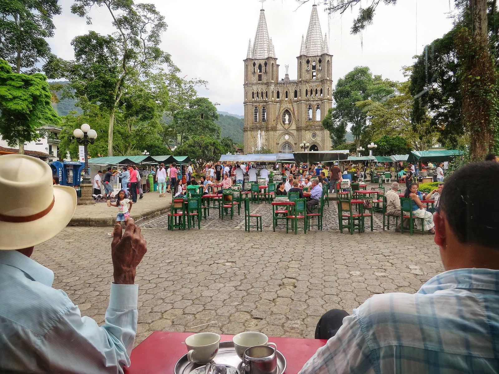 old men look out over Jardin's plaza in Colombia