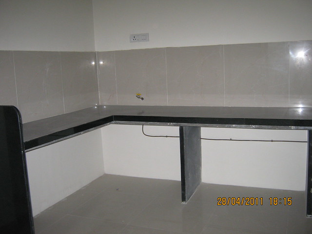 L Shaped Kitchen Platform with jet black granite top and piped gas connection in a flat at 