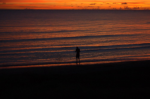 sunset shadow sky orange man night waves ripples tobago canoebay