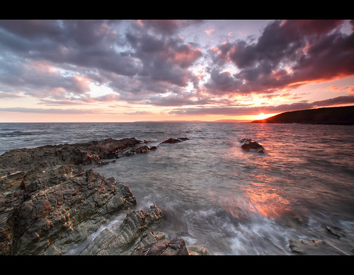 ocean pink ireland sunset red sea sun seascape landscape rocks waves hand cork rocky guileen