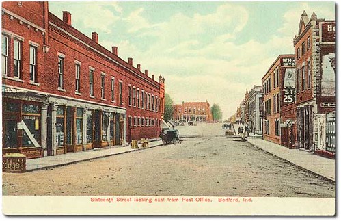 horses people usa signs color history buildings walking advertising awning bedford clothing indiana streetscene transportation shops pedestrians storefronts mills buggy buggies businesses barbers lawrencecounty hoosierrecollections