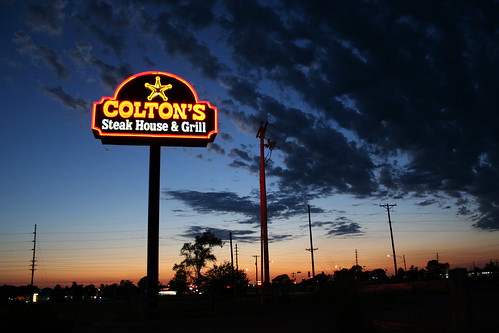 sunset sky sun sign neon pole steakhouse coltons
