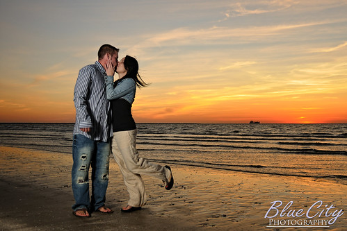 pictures ocean sky orange beach gulfofmexico water clouds portraits sunrise coast engagement sand kiss kissing couple texas photos shots tx young freeport engaged lakejackson quintana brazoriacounty bluecityphotography bluecityphotographycom