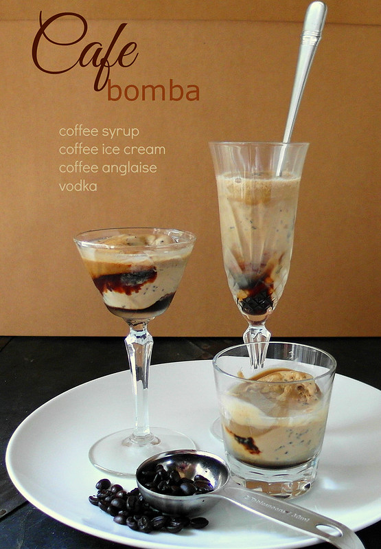 Photo of  Cafe Bomba, 3 servings. Each in a clear glass. One a champagne flute, one a footed dessert glass, and one an old fashioned glass. A long handled metal spoon is in the champagne flute. A metal tablespoon with coffee beans spilling out is next to the glasses. All are resting on a white round plate. The text reads: Cafe bomba. Coffee syrup, coffee ice cream, coffee anglaise, vodka.