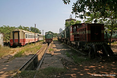 View of locos & passenger cars stored @ Phnom Penh depot