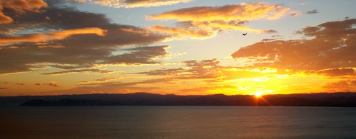 ocean sunset sea newzealand sun water clouds plane airplane flying aeroplane hills flare gisborne kaitihill
