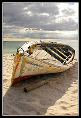 Mauritius - old battered boat on the beach 1