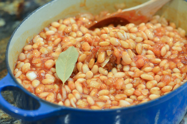 A bay leaf is added to the beans.