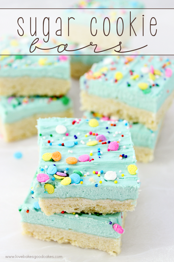 Sugar Cookie Bars stacked up on parchment paper.