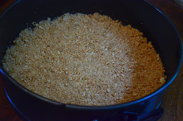 The crumb mixture is added to the bottom of a springform pan.