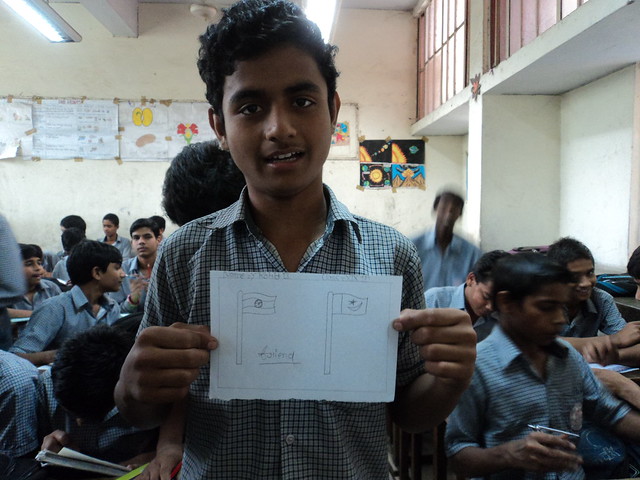 Student showing his drawing and message for people of Pakistan.