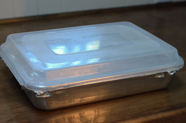 The plastic cover is placed on top of the pan.